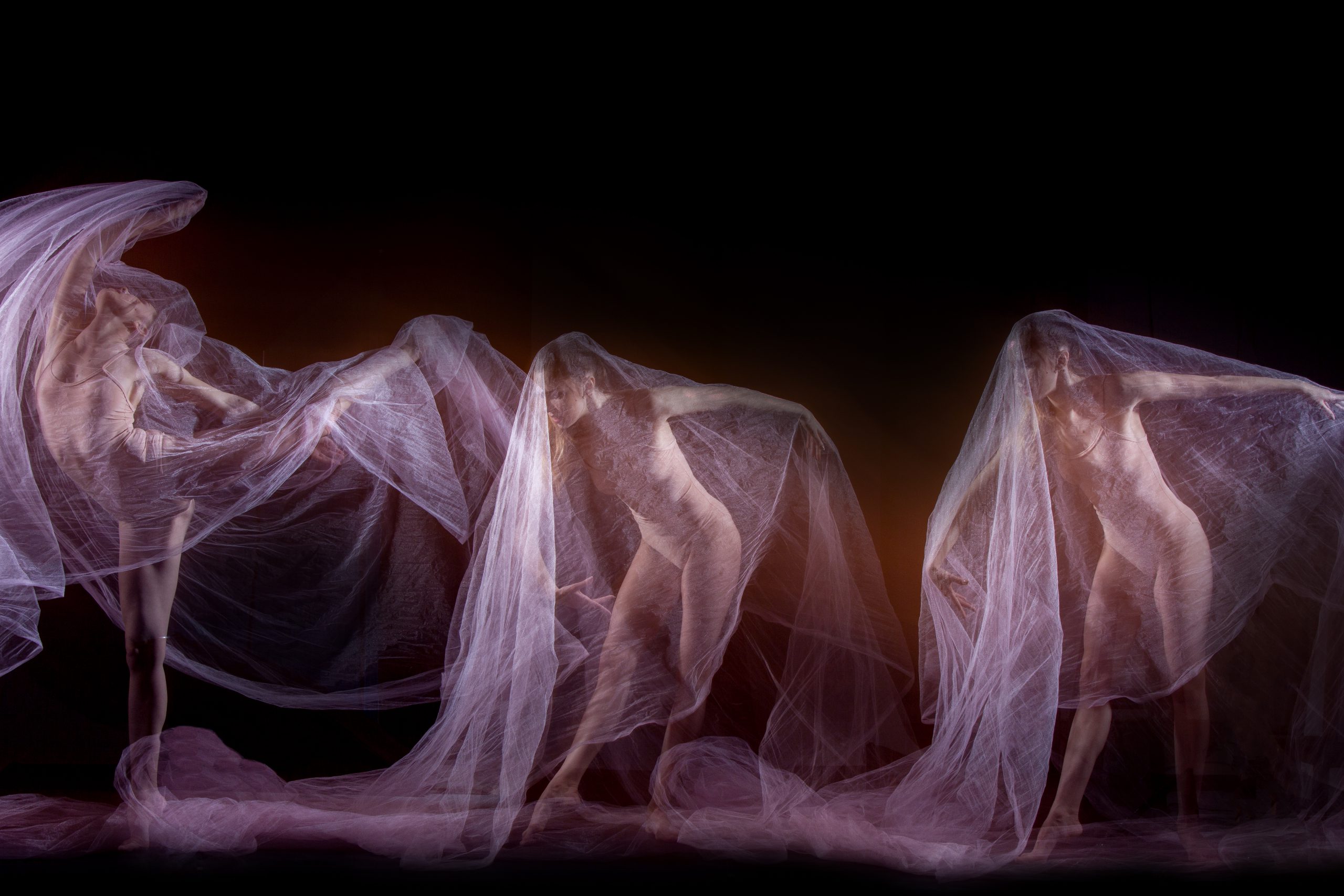 The sensual and emotional dance of beautiful ballerina with veil. Photography technique with strobe